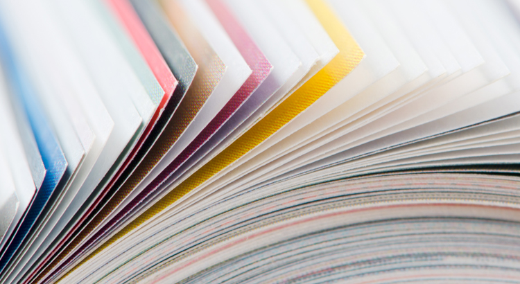 Multicoloured book pages and paperback book covers.