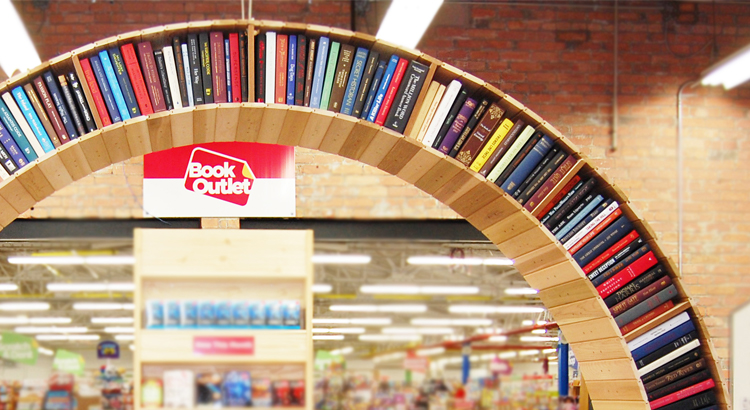 Wooden arch filled with books in book outlet store.